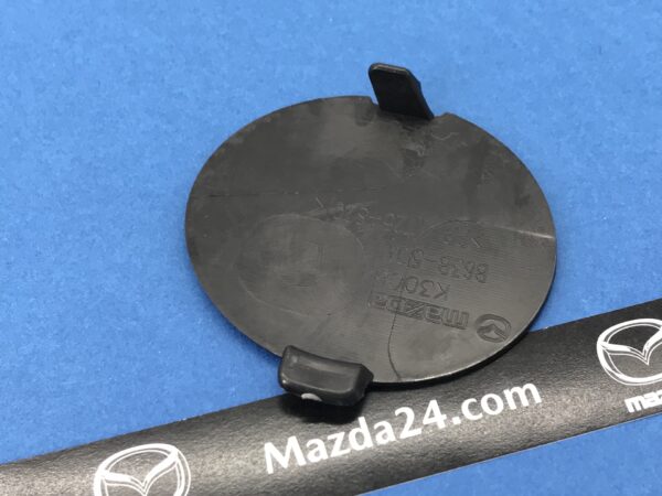 2017-2018 Mazda 3 front bumper tow took cover. Back side. Part numbers: B63B50A11BB, B63B-50-A11BB.