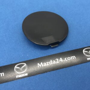 DK8A50A12ABB - Front bumper cover towing cap left Mazda CX-3