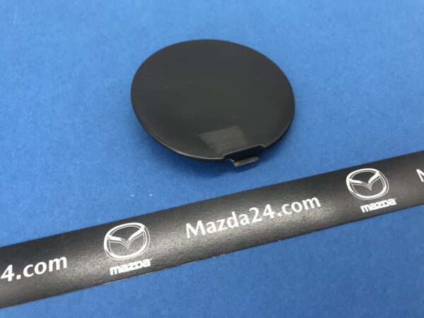 DK8A50A12ABB - Front bumper cover towing cap left Mazda CX-3